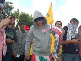 Youth marching against the Israeli bombing of Lebanon burn a poster of US President Bush