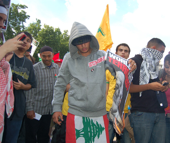 Youth marching against the Israeli bombing of Lebanon burn a poster of US President Bush