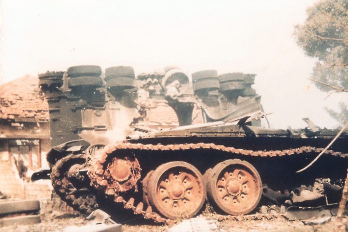 Sri Lankan army vehicles smoulder after a Tamil Tiger assault