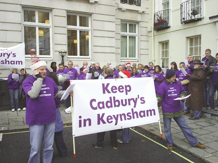 Cadbury’s workers singing Christmas carols outside the Cadbury Schweppes headquarters in Berkeley Square yesterday. The company wants to export their jobs to Poland