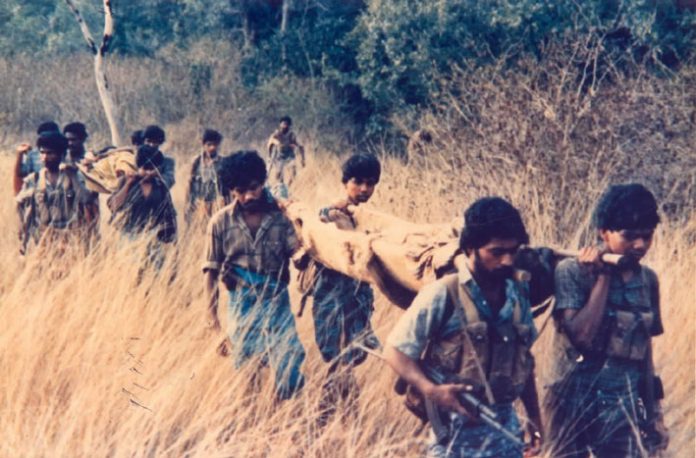 Tamil Tigers carry their wounded to safety