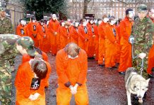 Hundreds of demonstrators yesterday re-enacted the humiliation of detainees by US troops at Guantanamo Bay, demanding the concentration camp’s immediate closure