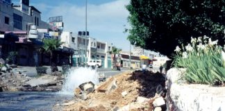 Water main in the Palestinian West Bank  burst by an Israeli army tank