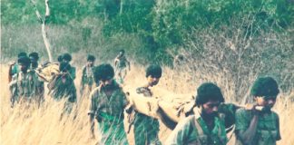 Tamil Tiger fighters carrying their wounded through the countryside