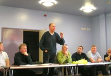 Bert Schouwenberg, GMB full-time officer (centre), addressing a mass meeting of caretakers in Fulham yesterday