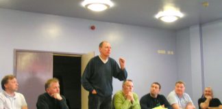 Bert Schouwenberg, GMB full-time officer (centre), addressing a mass meeting of caretakers in Fulham yesterday
