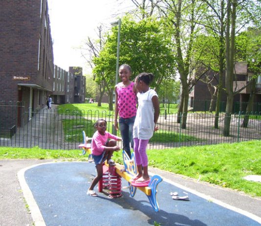 Children playing on the Grahame Park estate in front of the houses that are due to be demolished