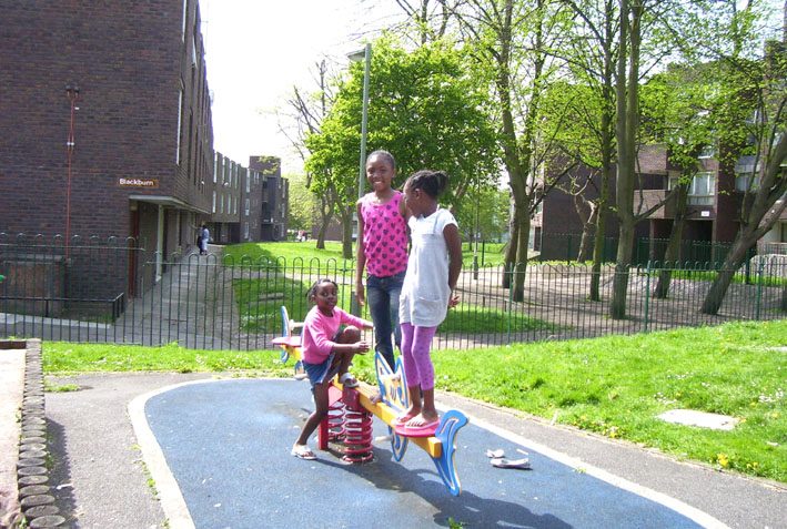 Children playing on the Grahame Park estate in front of the houses that are due to be demolished