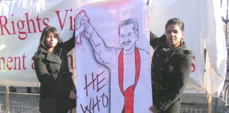 Protesters in Downing Street hold a poster of Rajapaksa on February 4th 2008 – the 60th anniversary of Sri Lankan independence