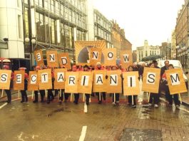 McGUINNESS PLEDGES WAR ON RACISM Communication Workers Union banner at the front of a demonstration during the general strike in Belfast in January 2002 following the sectarian killing of a young postal worker