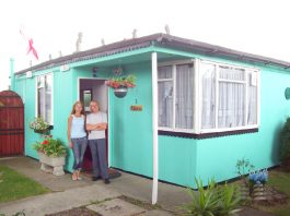 JIM BLACKENDER with his wife outside their home on the Excaliber Estate