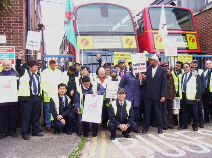 Striking bus workers fighting for fair pay outside Alperton bus garage yesterday morning