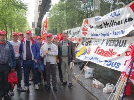 Peugeot workers lobby a shareholders meeting against factory closures in May 2006