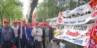 Peugeot workers lobby a shareholders meeting against factory closures in May 2006