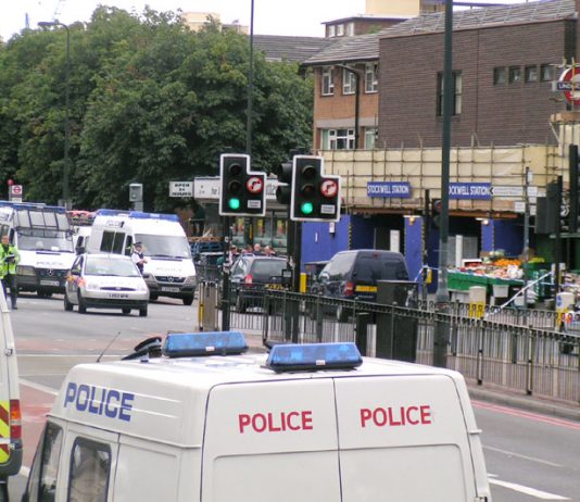 Police surround Stockwell tube station after armed officers brutally executed Jean Charles de Menezes on July 22, 2005