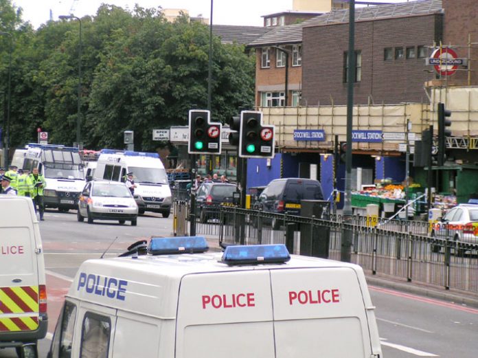 Police surround Stockwell tube station after armed officers brutally executed Jean Charles de Menezes on July 22, 2005