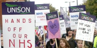 NHS workers and their families marching to defend the service from the privateers