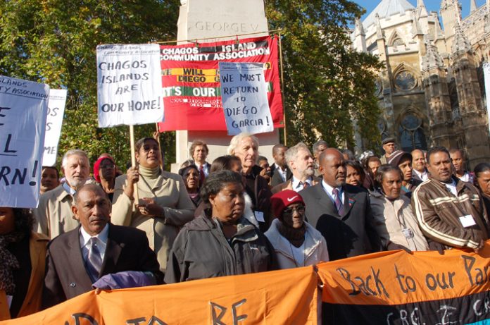 Journalist JOHN PILGER (centre) joins HENGRIDE PERMAL (left of centre) and OLIVIER BANCOULT (third from the right, front row) in a demonstration against the House of Lords ruling yesterday