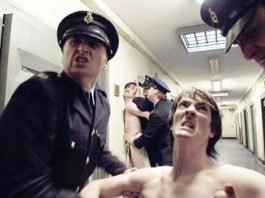 Naked H-Block prisoners in the hands of prison officers in a scene from the film