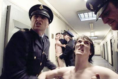 Naked H-Block prisoners in the hands of prison officers in a scene from the film