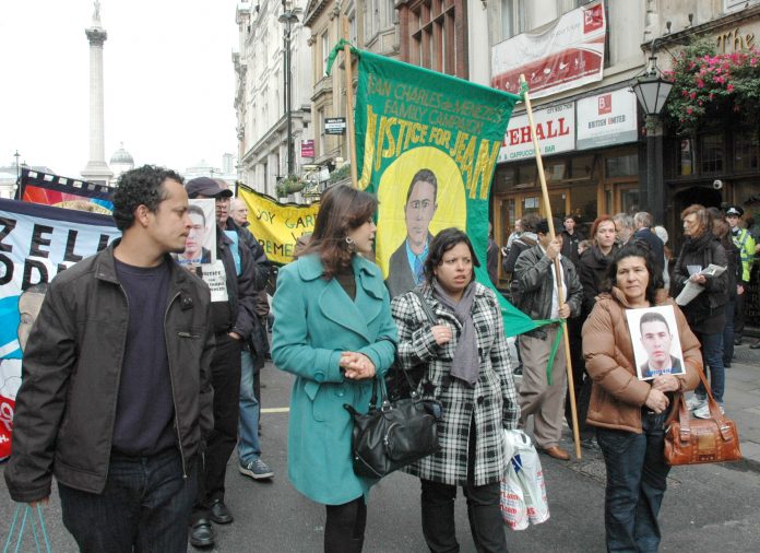 MARIA OTONE DE MENEZES (right) holds a picture of her son Jean Charles de Menezes on the United  Friends and Families Campaign demonstration on October 25