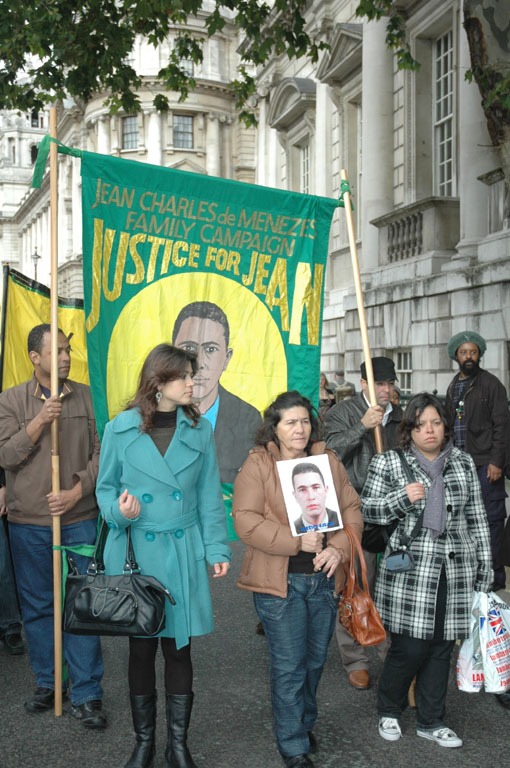 MARIA OTONE DE MENEZES (centre) holds a picture of her son Jean Charles De Menezes on a march to parliament