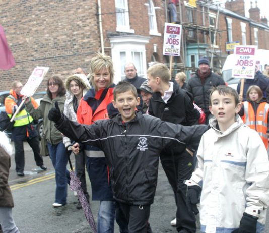 Postal workers and their families marching in Crewe on October 25 demanding the Mail Centre be kept open