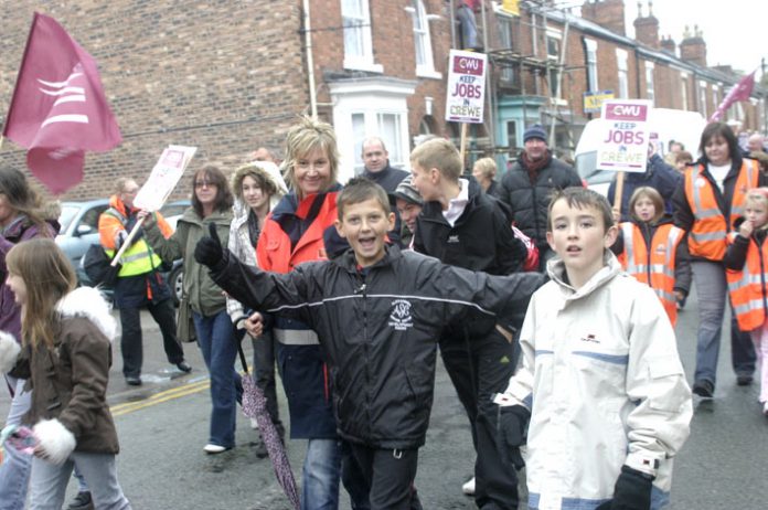 Postal workers and their families marching in Crewe on October 25 demanding the Mail Centre be kept open