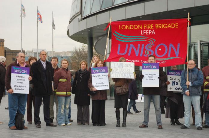 London fire service staff outside City Hall yesterday to demand the withdrawal of threatened cuts
