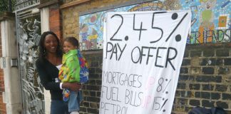 A school worker with her child during national strike action in July against a below-inflation pay deal