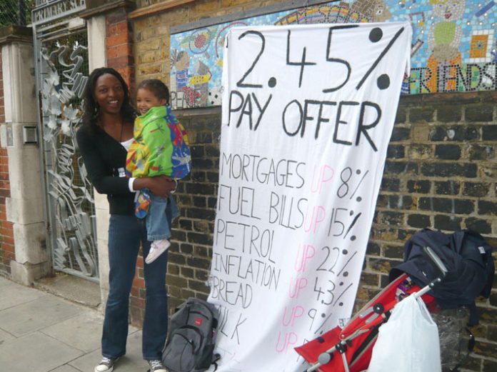 A school worker with her child during national strike action in July against a below-inflation pay deal