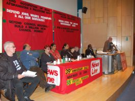 The platform at the News Line Anniversary Rally. Left to right: Hank Roberts, Vally Wilson, Zina Dodgson, Lakhinder Saran, Sheila Torrance (chair), Paddy O’Regan, Nimalan Sevaranam and Dave Wiltshire (ATUA National Secretary, speaking)