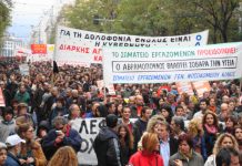 Greek workers marching through Athens during the nationwide revolt that continued into a third week yesterday