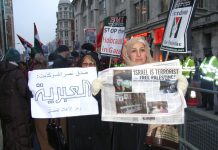 Demonstrators hold up the News Line which perfectly expresses their feelings about the terrorist state of Israel