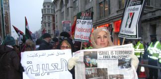 Demonstrators hold up the News Line which perfectly expresses their feelings about the terrorist state of Israel