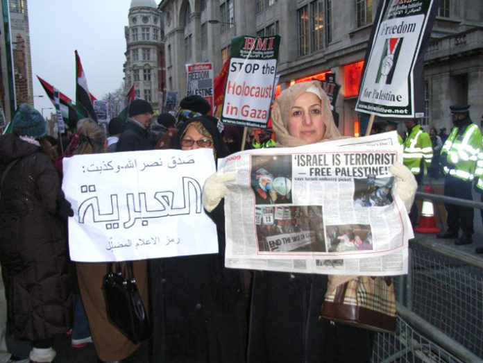 Demonstrators hold up the News Line which perfectly expresses their feelings about the terrorist state of Israel