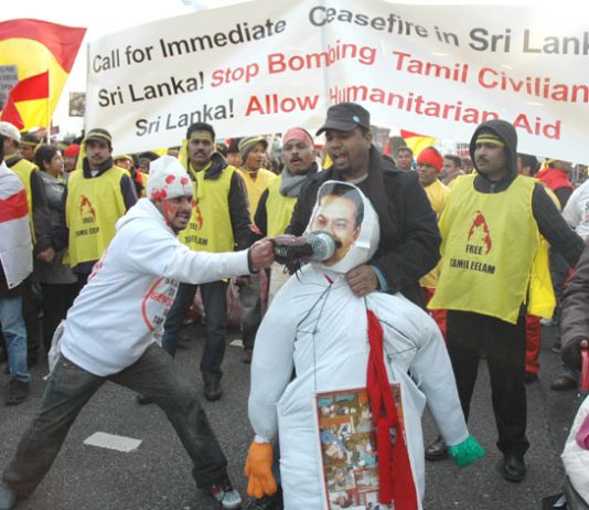 A Tamil marcher bashes an effigy of Sri Lankan President Rajapakse with his shoe – More than 120,000 Tamils and their supporters marched in London on Saturday to demand a halt to the shelling of Tamil areas in northern Sri Lanka and no more UK support for