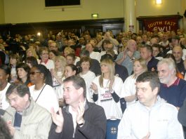 A section of the audience applauding the call for strike action
