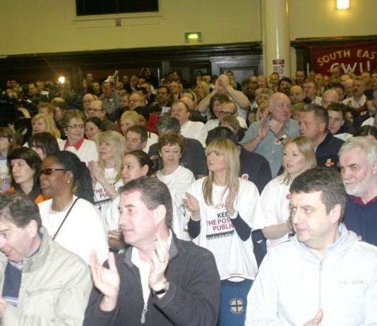 A section of the audience applauding the call for strike action