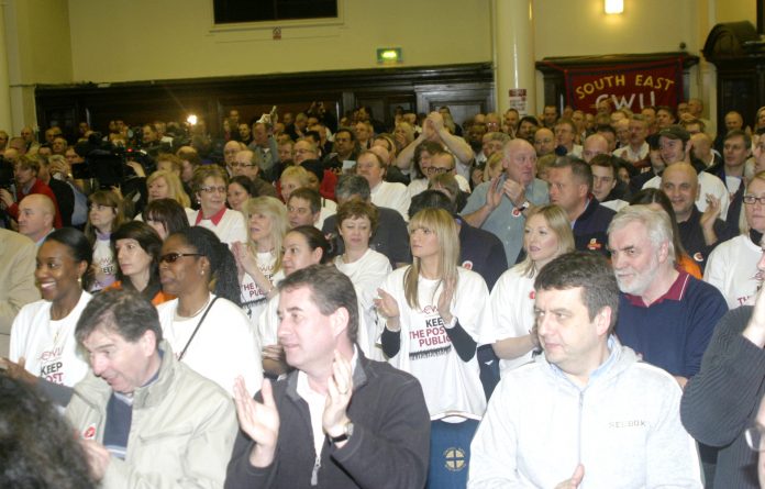 A section of the audience applauding the call for strike action