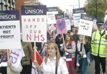 NHS workers marching in defence of the NHS stressing it is not about profit
