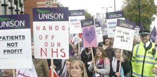 NHS workers marching in defence of the NHS stressing it is not about profit