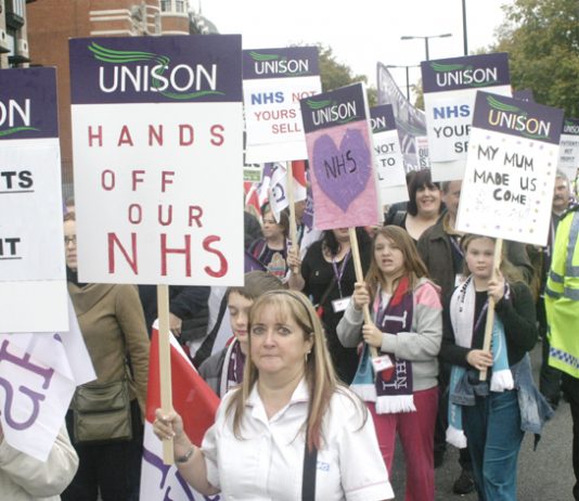 NHS workers marching in defence of the NHS stressing it is not about profit