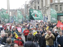 COWEN INVITES ICTU TO TALKS – as massive strike action approaches SIPTU banners on the 125,000-strong demonstration in Dublin on February 21 against wage cuts and job losses