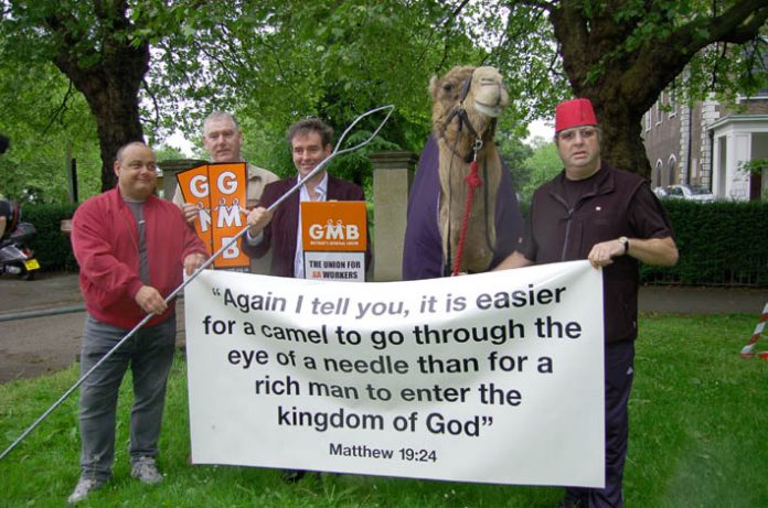 GMB members with a camel protest outside a church in Clapham against Damon Buffini, the head of the Permira venture capitalist group which owned the AA at the time