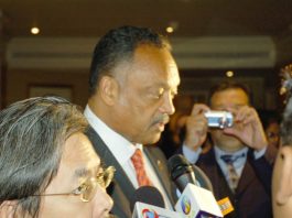 Jesse Jackson (centre) leaving the World Tamil Conference in London on Thursday