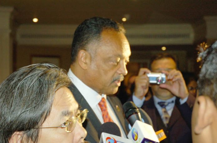 Jesse Jackson (centre) leaving the World Tamil Conference in London on Thursday
