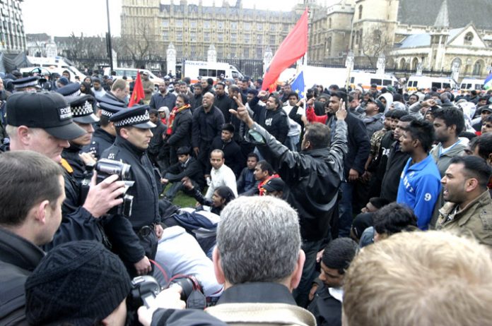 Angry Tamils confront police in Parliament Square after being forcibly removed from Westminster Bridge