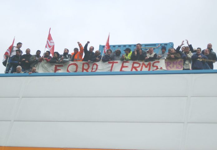 Visteon workers in a show of defiance on the roof before Unite officials got them to leave the factory at noon yesterday