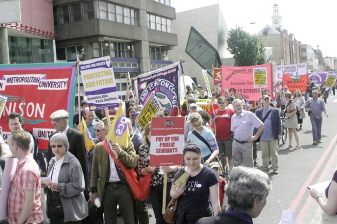UCU, Unison and PCS members marching past London Met in Holloway Road